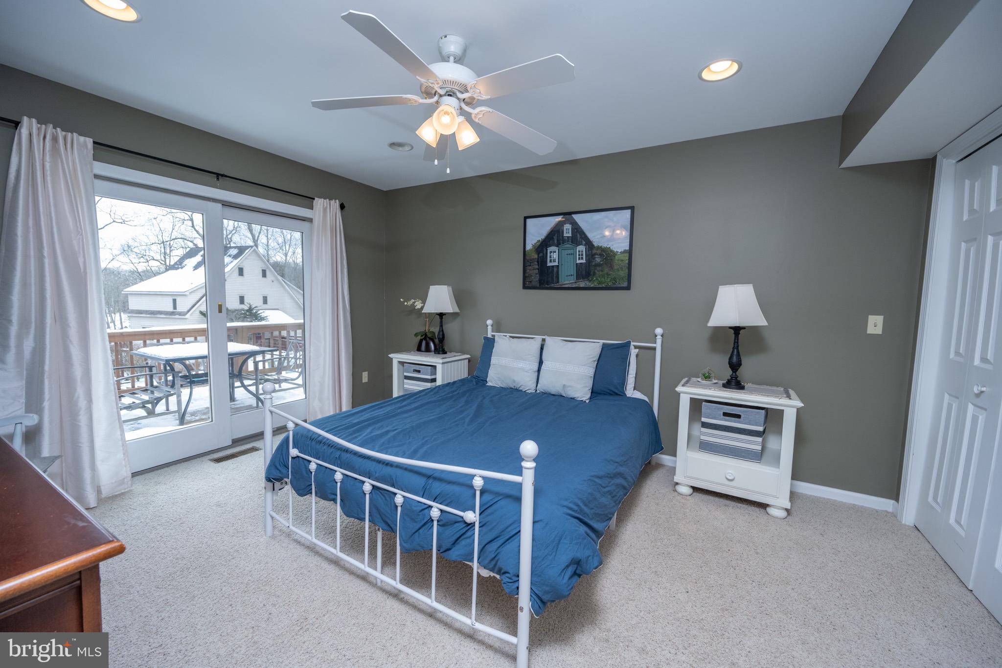 175 Roman Ridge Road, Unit 15 Oakland, MD 21550 - Photo 15 of 53 a bedroom with a bed and a large window