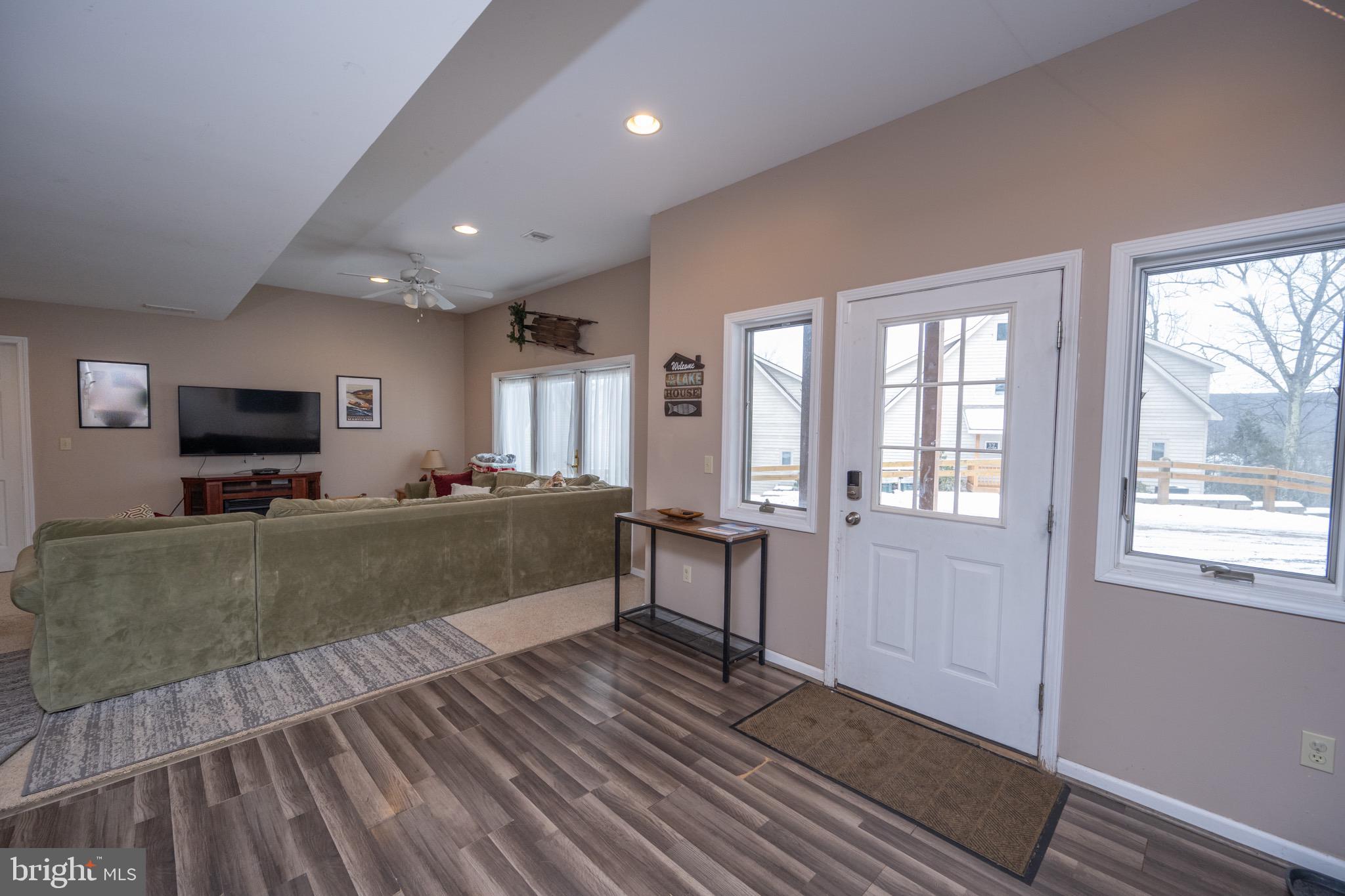 175 Roman Ridge Road, Unit 15 Oakland, MD 21550 - Photo 19 of 53 a living room with furniture and a flat screen tv