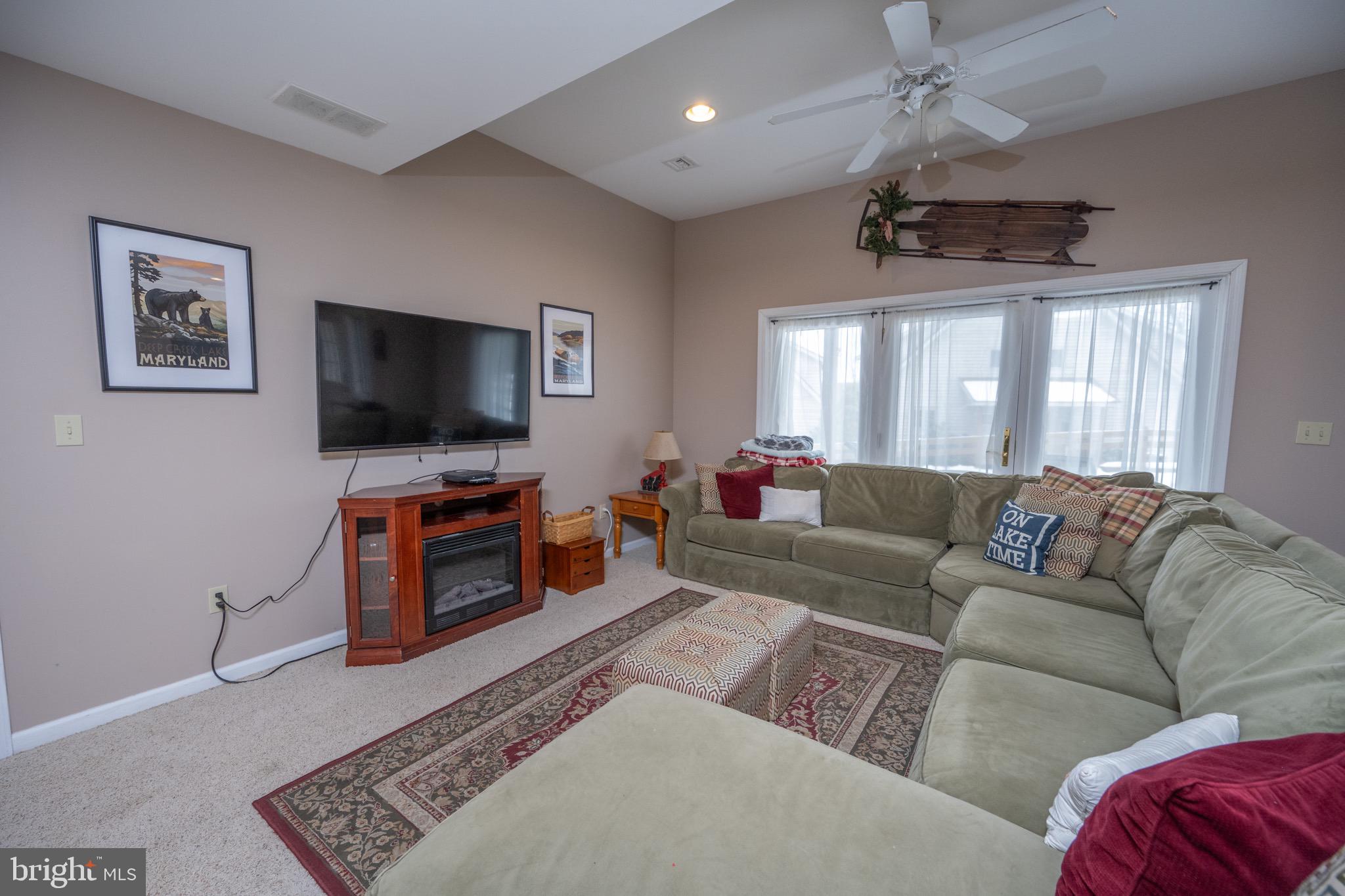 175 Roman Ridge Road, Unit 15 Oakland, MD 21550 - Photo 21 of 53 a living room with furniture and a flat screen tv