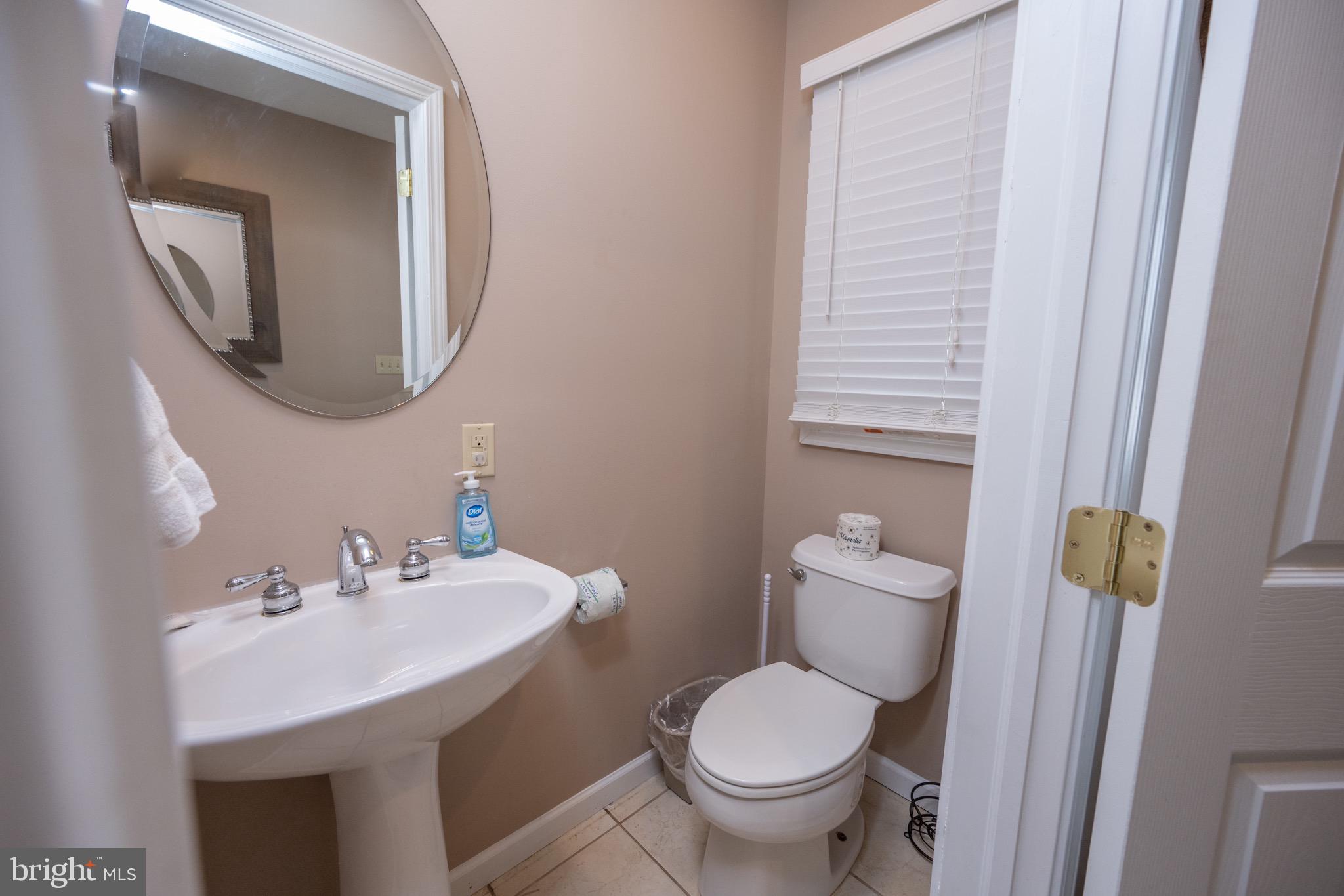 175 Roman Ridge Road, Unit 15 Oakland, MD 21550 - Photo 26 of 53 a bathroom with a toilet sink and mirror