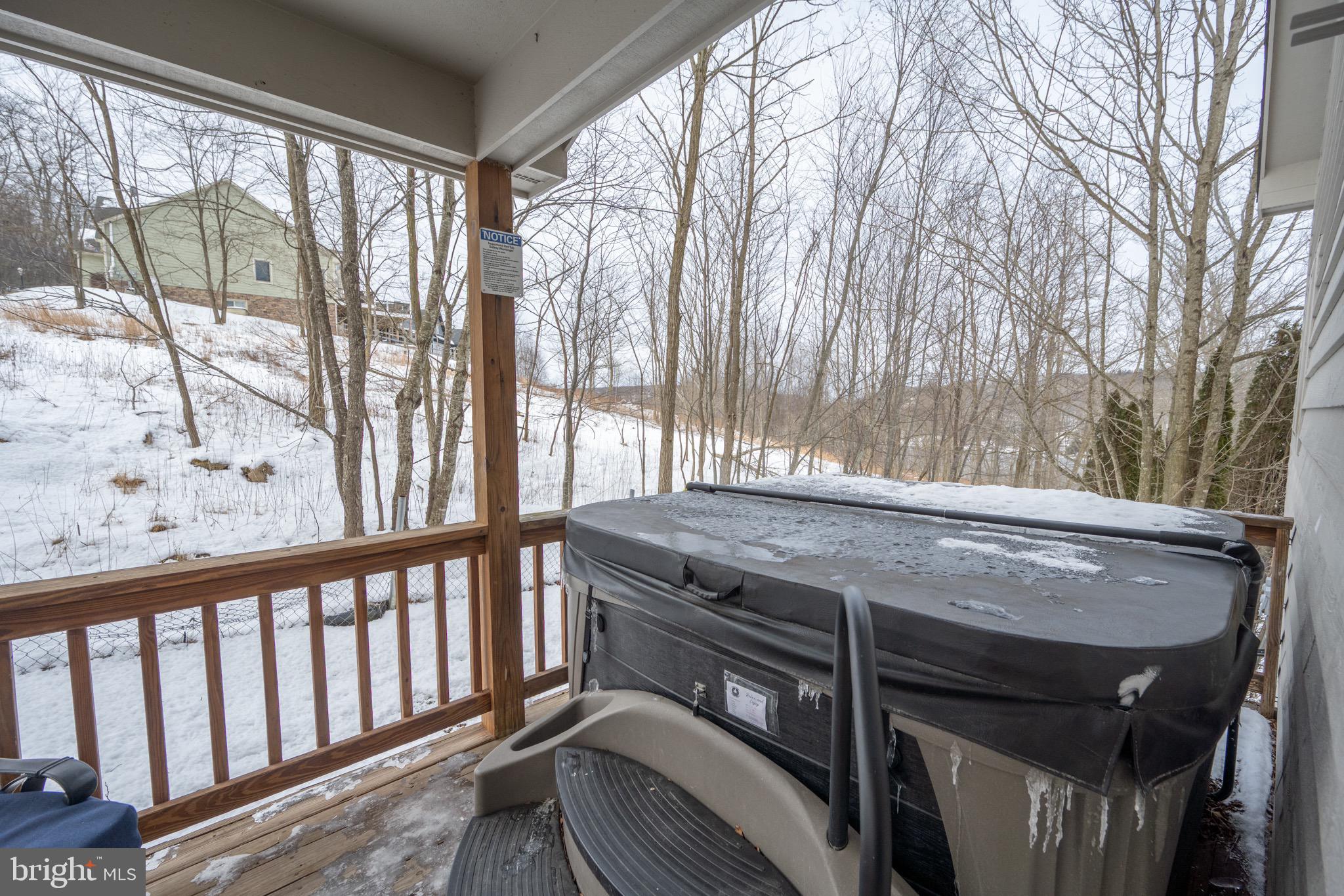 175 Roman Ridge Road, Unit 15 Oakland, MD 21550 - Photo 27 of 53 a view of a balcony with furniture and a backyard