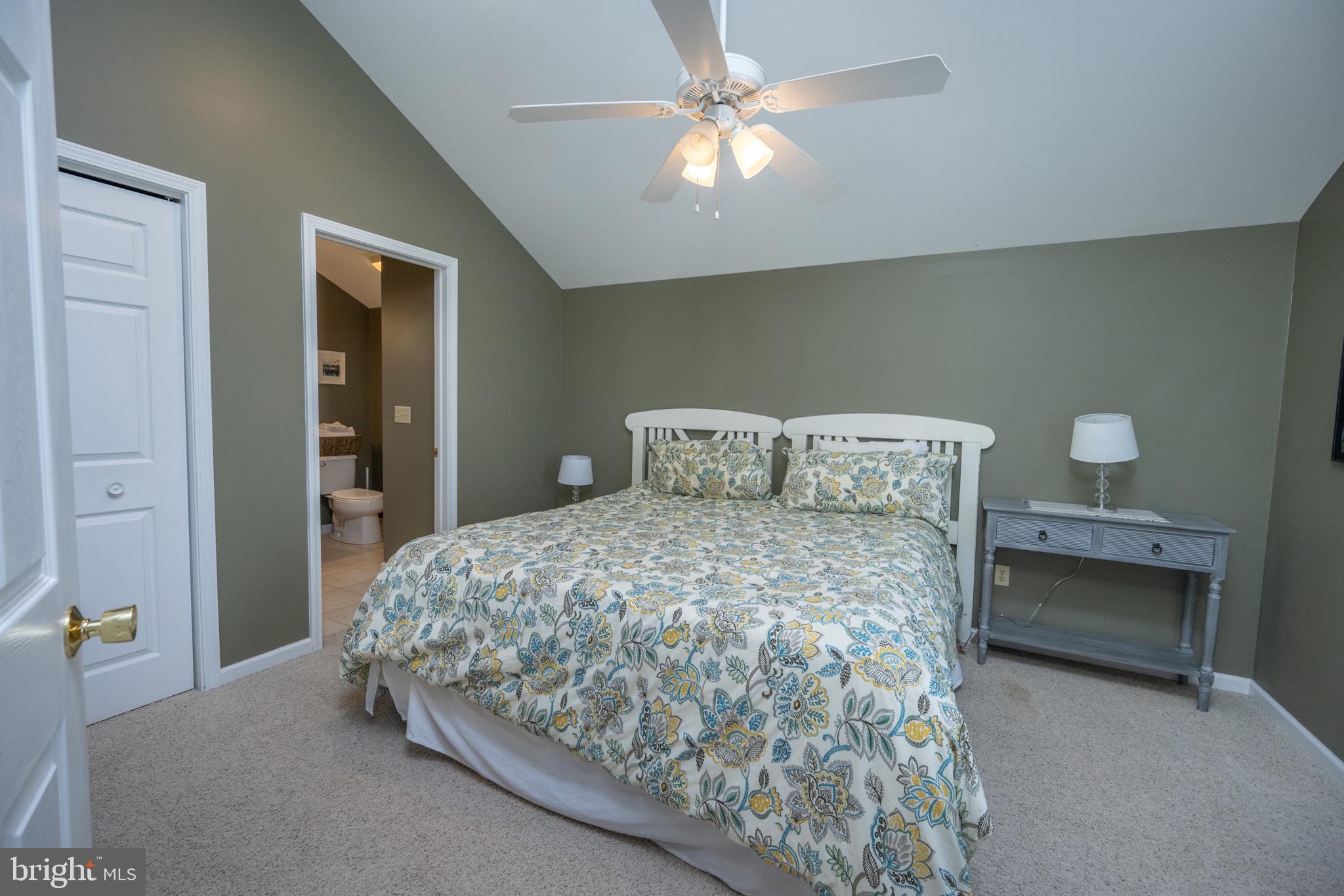 175 Roman Ridge Road, Unit 15 Oakland, MD 21550 - Photo 30 of 53 a bedroom with a bed and a chandelier