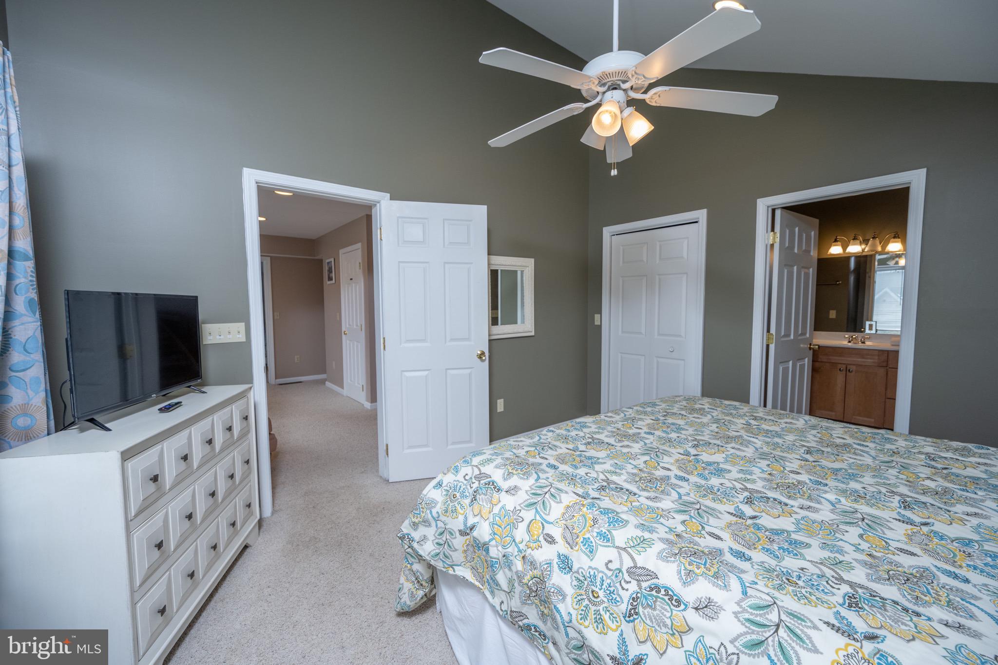 175 Roman Ridge Road, Unit 15 Oakland, MD 21550 - Photo 31 of 53 a bedroom with a bed and a flat tv screen on dresser