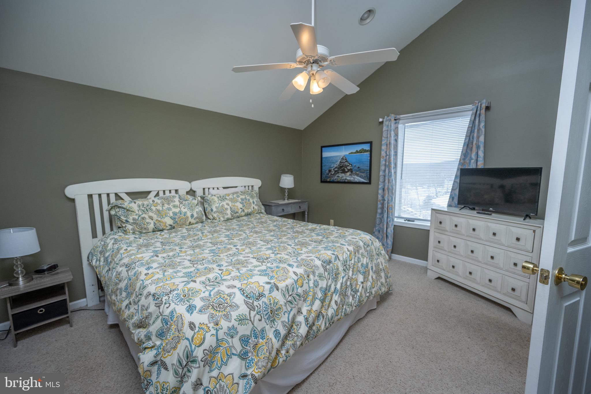 175 Roman Ridge Road, Unit 15 Oakland, MD 21550 - Photo 32 of 53 a bed sitting in a bedroom and chandelier