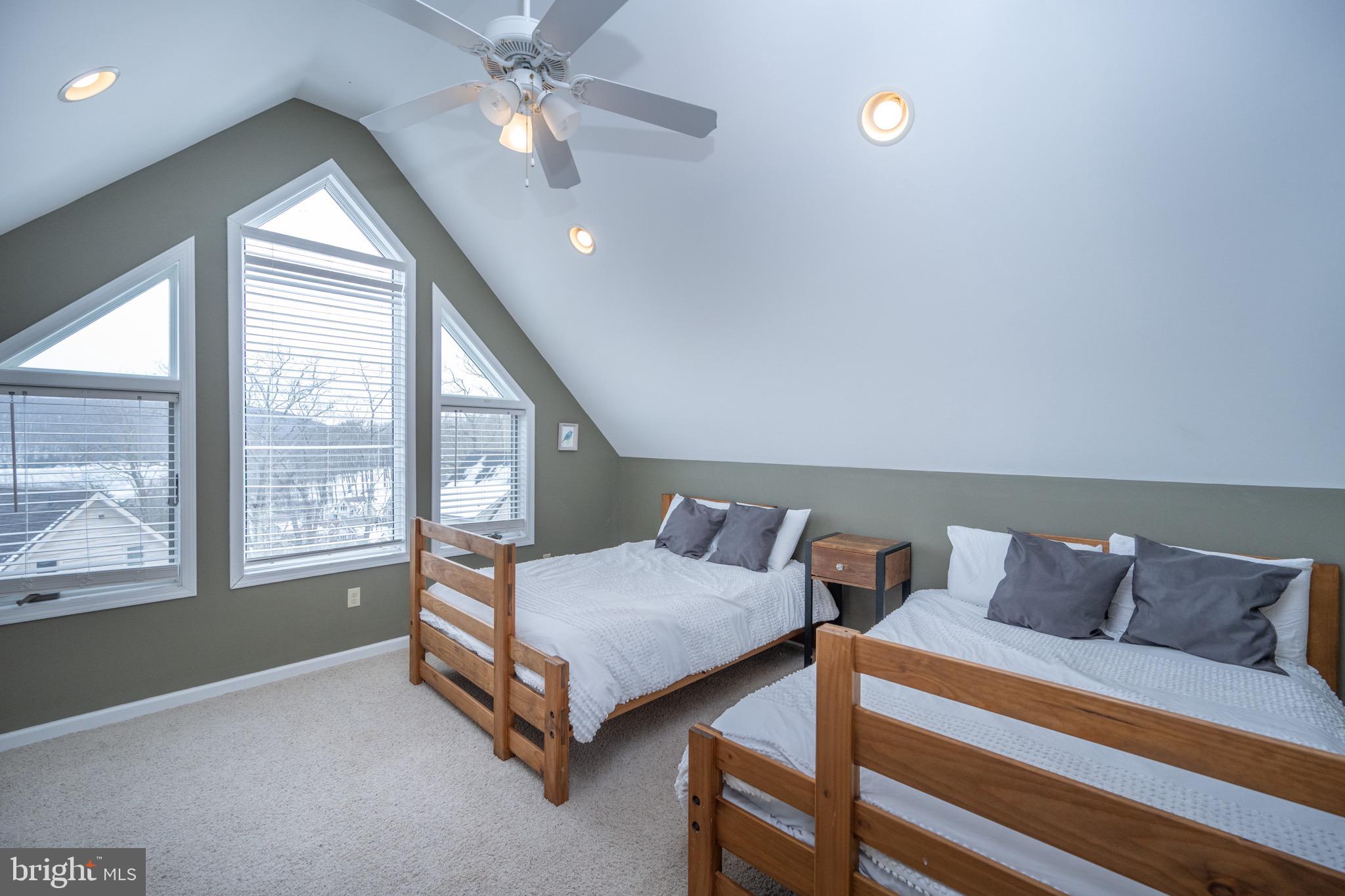 175 Roman Ridge Road, Unit 15 Oakland, MD 21550 - Photo 43 of 53 a bedroom with two beds and window