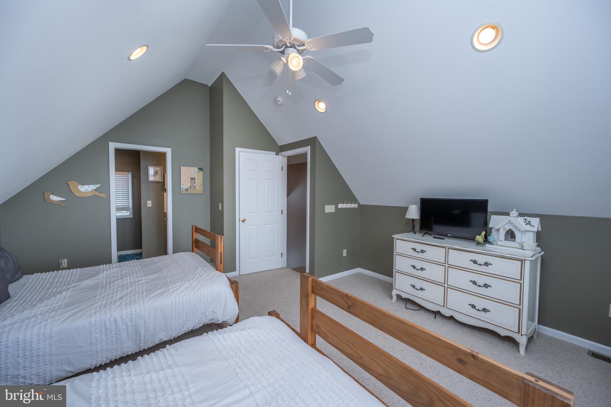 175 Roman Ridge Road, Unit 15 Oakland, MD 21550 - Photo 46 of 53 a bedroom with a bed and a chandelier