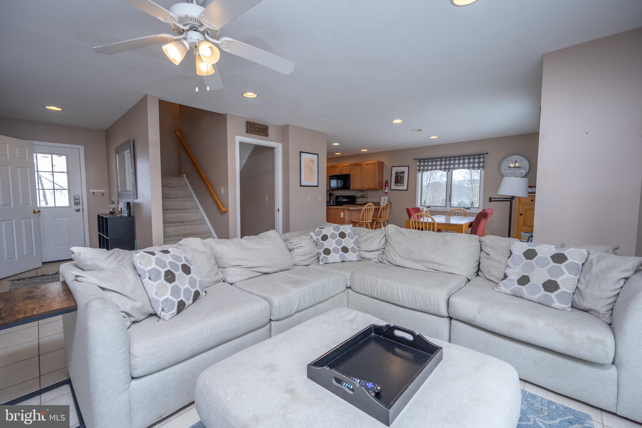 175 Roman Ridge Road, Unit 15 Oakland, MD 21550 - Photo 6 of 53 a living room with furniture and a large window
