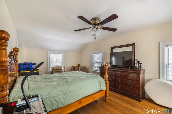 a bedroom with a bed and a flat screen tv