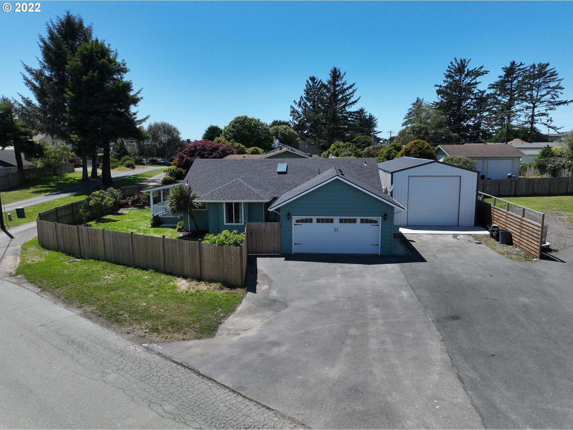 a front view of a house with a yard and trees