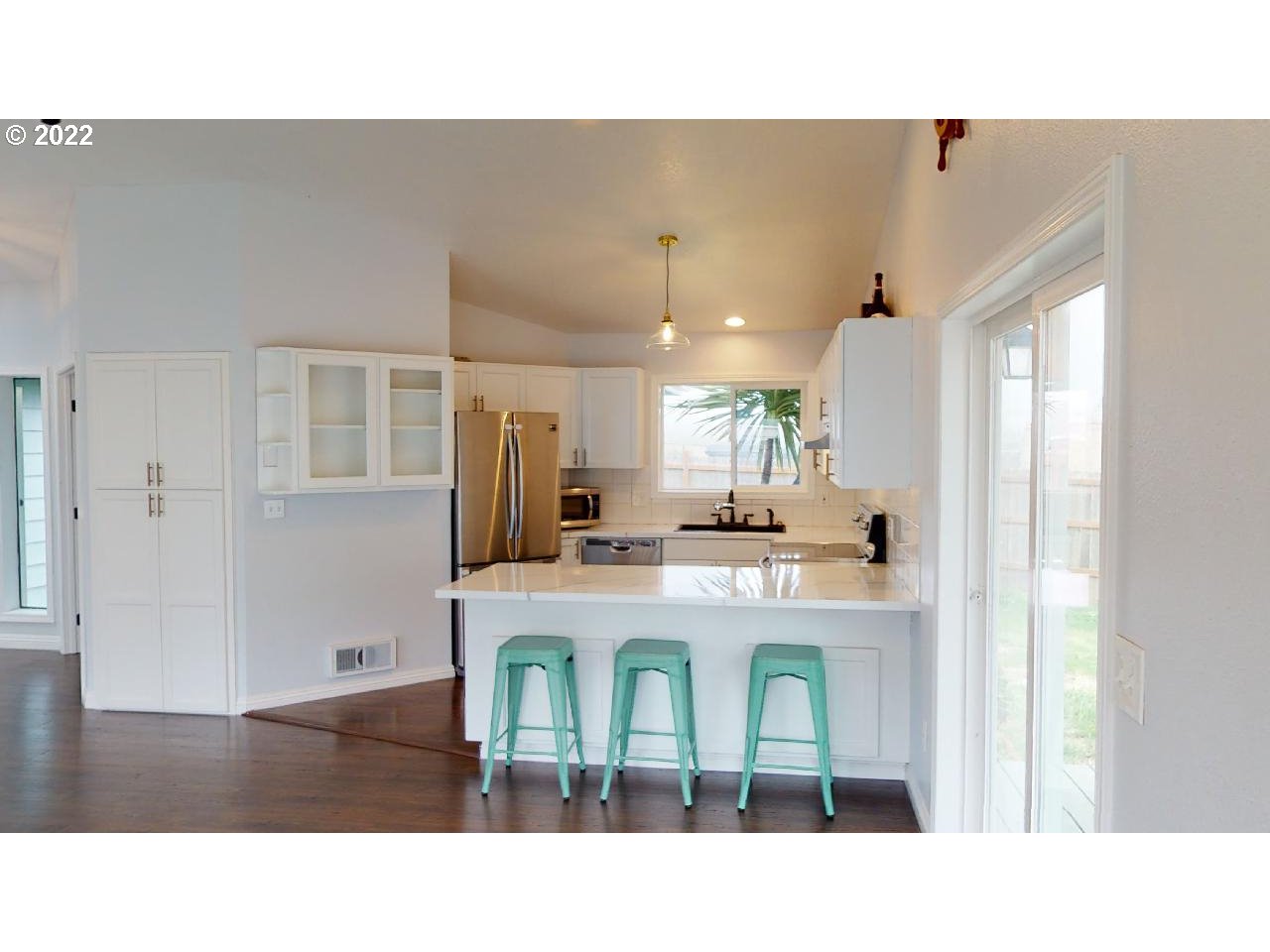 335 Mill Beach Road Brookings, OR 97415 - Photo 4 of 32 a kitchen with kitchen island a stove a refrigerator a dining table and chairs