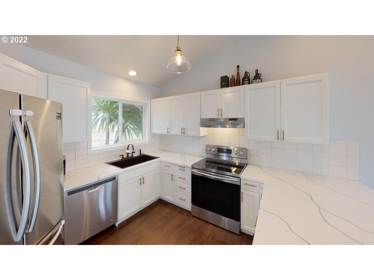335 Mill Beach Road Brookings, OR 97415 - Photo 6 of 32 a kitchen with stainless steel appliances granite countertop a refrigerator sink and stove