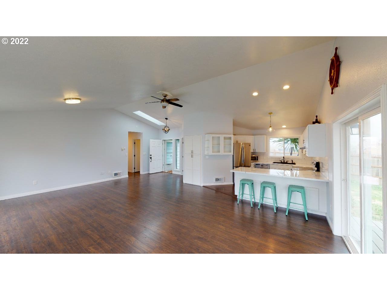 335 Mill Beach Road Brookings, OR 97415 - Photo 10 of 32 a living room with kitchen island furniture and a kitchen view