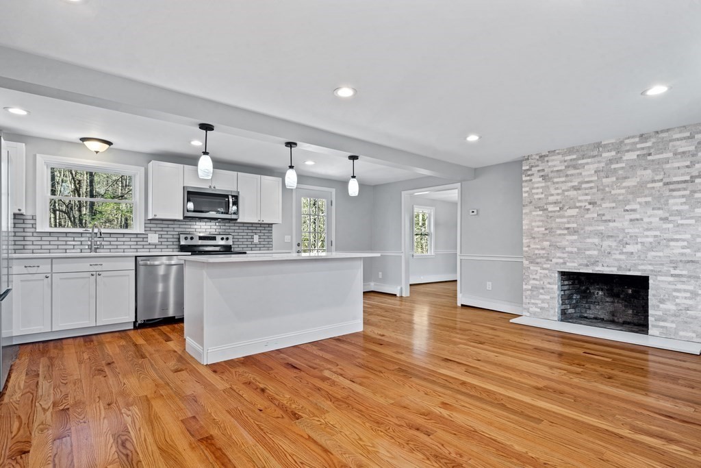 184 Booth Hill Road Scituate, MA 02066 - Photo 11 of 32 a large kitchen with cabinets wooden floor and a sink