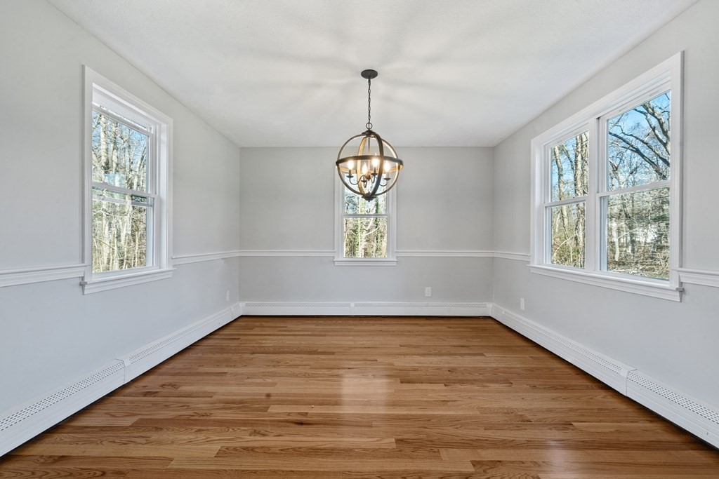 184 Booth Hill Road Scituate, MA 02066 - Photo 14 of 32 a view of an empty room with wooden floor and a window