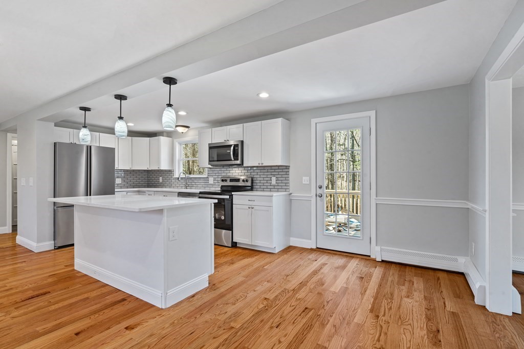 184 Booth Hill Road Scituate, MA 02066 - Photo 19 of 32 a kitchen with a refrigerator and a stove top oven