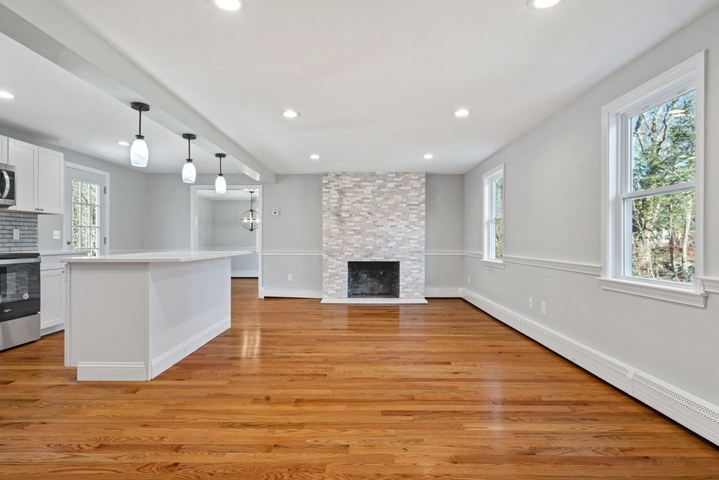 184 Booth Hill Road Scituate, MA 02066 - Photo 20 of 32 a view of a kitchen with a sink and a fireplace