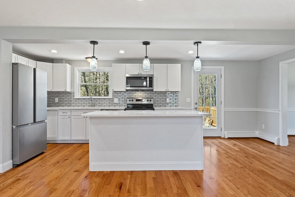 184 Booth Hill Road Scituate, MA 02066 - Photo 21 of 32 a large kitchen with cabinets wooden floor and stainless steel appliances