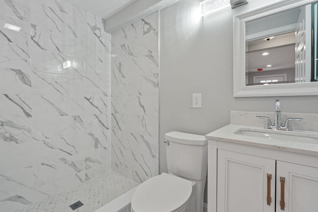 184 Booth Hill Road Scituate, MA 02066 - Photo 22 of 32 a bathroom with a granite countertop sink toilet and shower