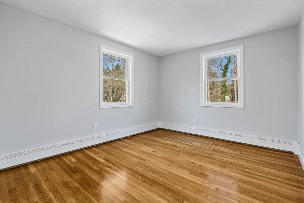 184 Booth Hill Road Scituate, MA 02066 - Photo 25 of 32 a view of an empty room with wooden floor and a window