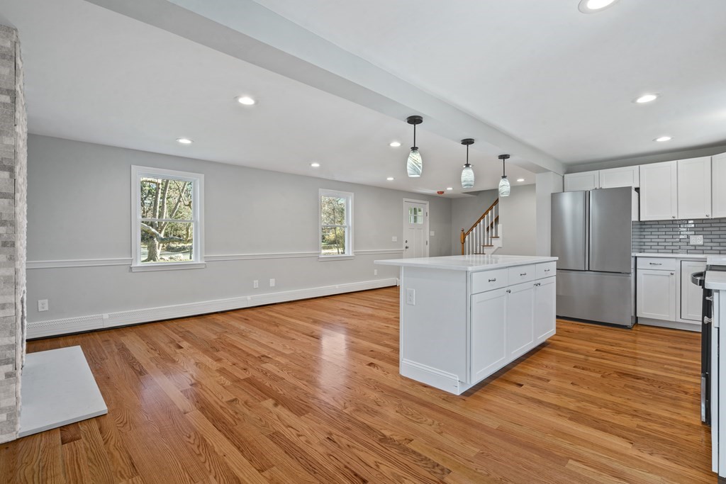 184 Booth Hill Road Scituate, MA 02066 - Photo 9 of 32 a kitchen with stainless steel appliances kitchen island wooden floors wooden cabinets and entryway