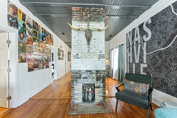 a bedroom with a large bed and a painting on the wall