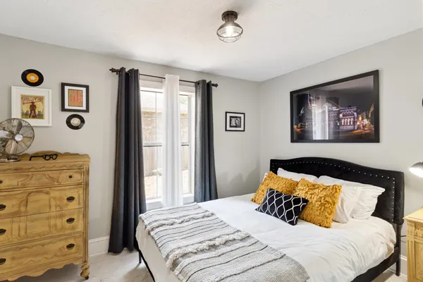 a bedroom with a bed and a painting on the wall