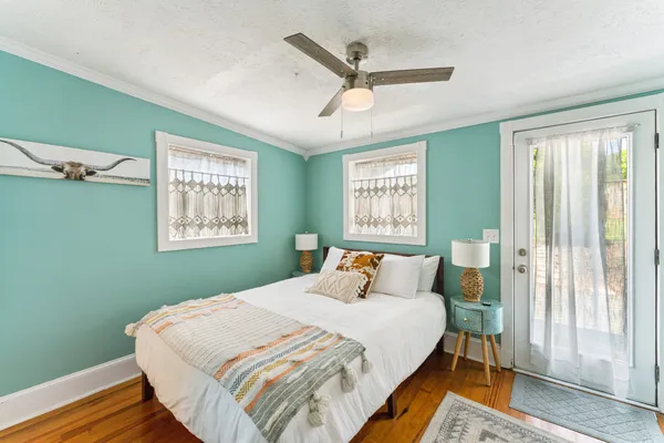 a bedroom with a bed and a painting on the wall