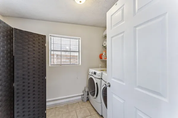 a kitchen with a sink a refrigerator and a stove