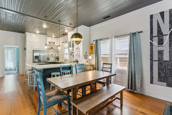 a dining room with furniture and wooden floor