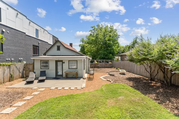 a view of a house with a backyard