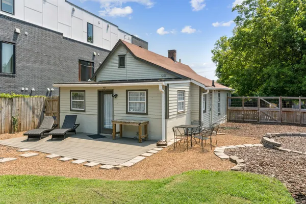 a view of a house with a yard and a fence