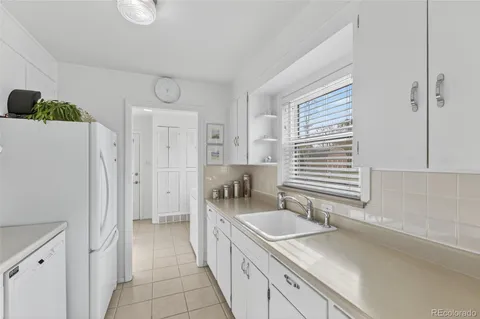 a kitchen with refrigerator and cabinets