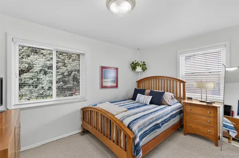 a view of a bedroom with a bed and wooden floor