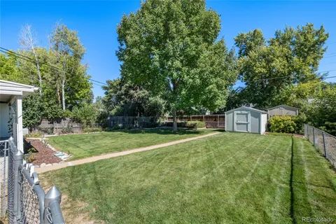 a view of house with backyard outdoor seating and green space