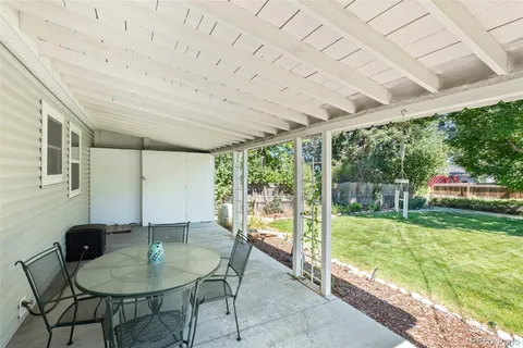 a view of a backyard with sitting area