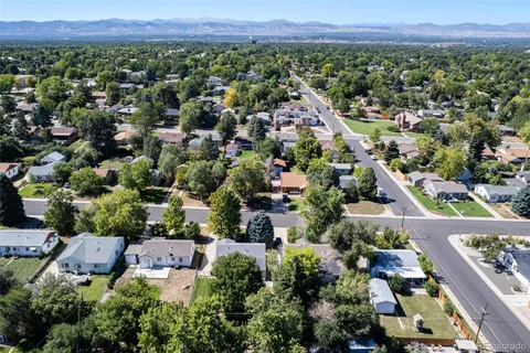 an aerial view of a house with a yard and garden