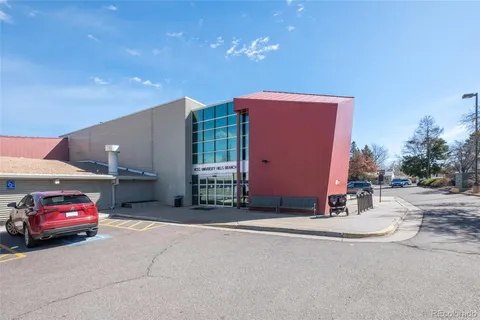 a view of street with sign on the side of building