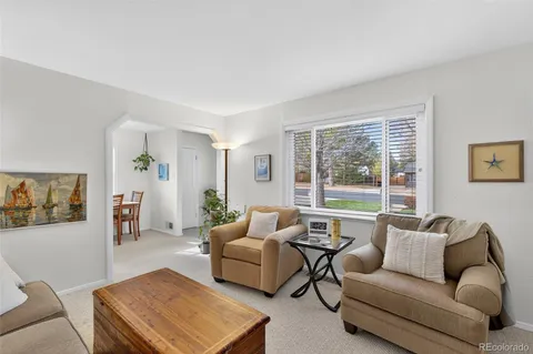 a dining room with furniture and a window