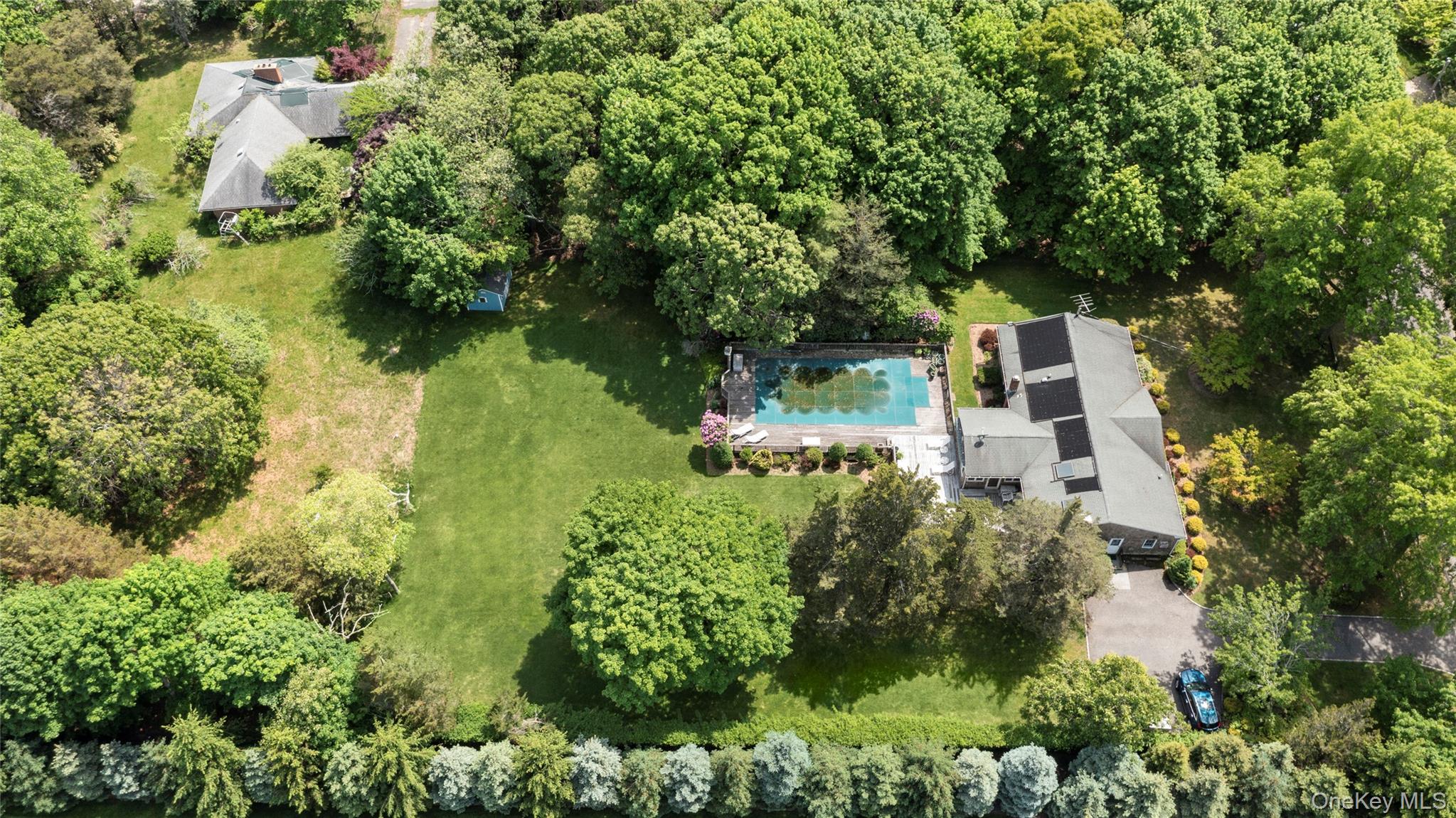 250 Paradise Point Road Southold, NY 11971 - Photo 20 of 24 an aerial view of residential house with outdoor space and trees all around