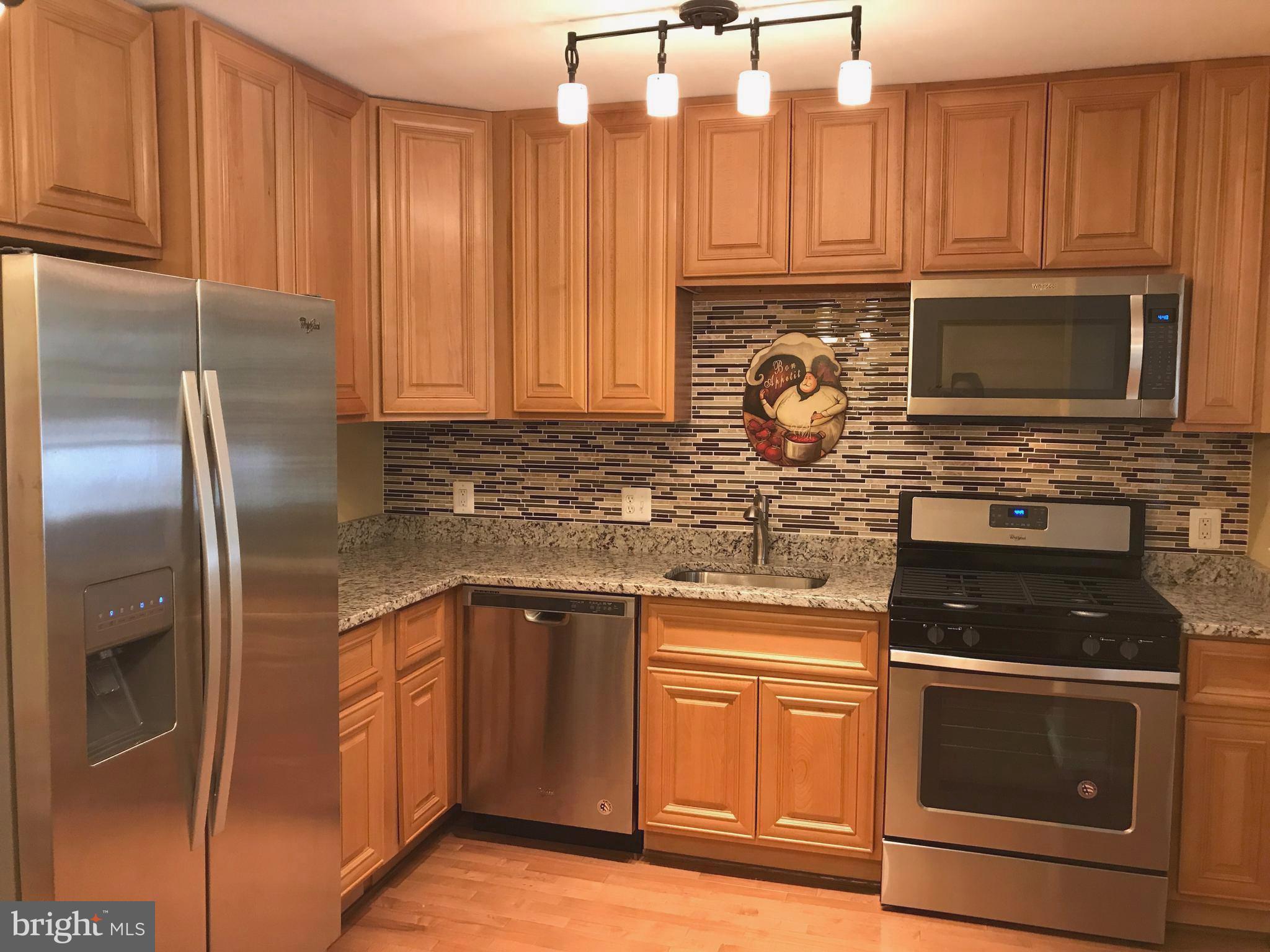 505 Welbrook Road Baltimore, MD 21221 - Photo 2 of 27 a kitchen with stainless steel appliances granite countertop a stove a microwave and a sink
