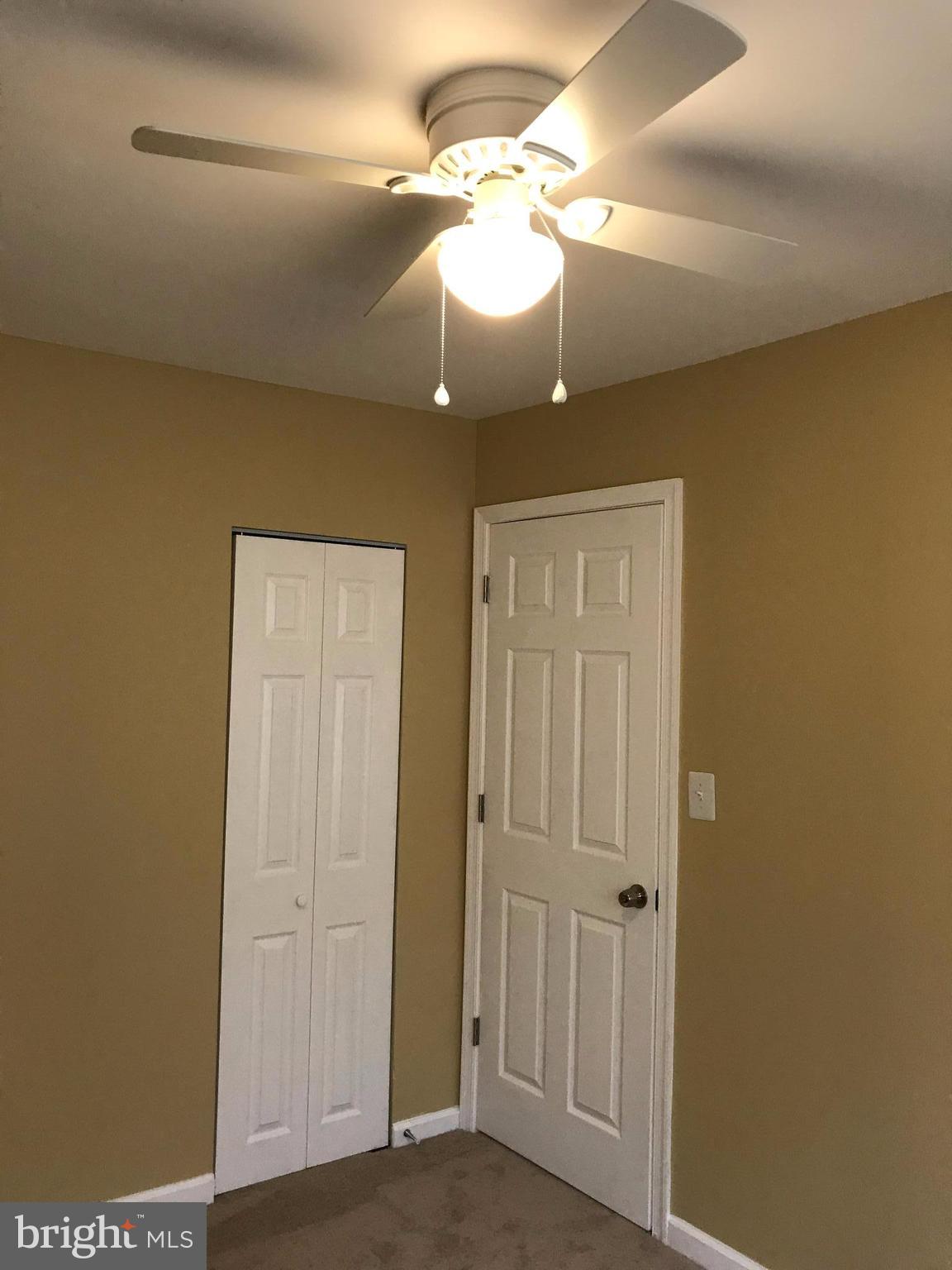 505 Welbrook Road Baltimore, MD 21221 - Photo 15 of 27 a view of a hallway with a chandelier fan and a table