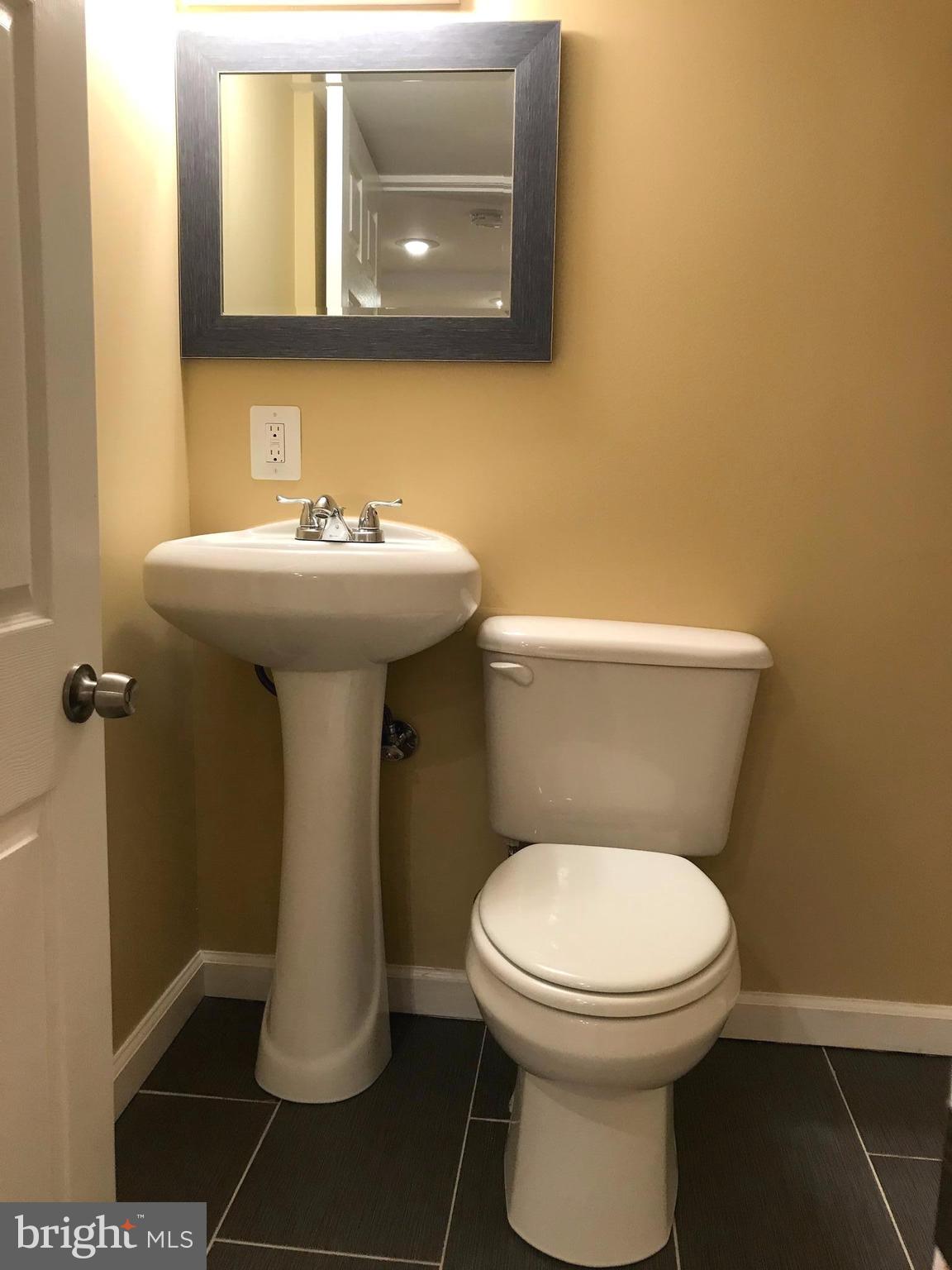 505 Welbrook Road Baltimore, MD 21221 - Photo 18 of 27 a bathroom with a toilet sink and mirror