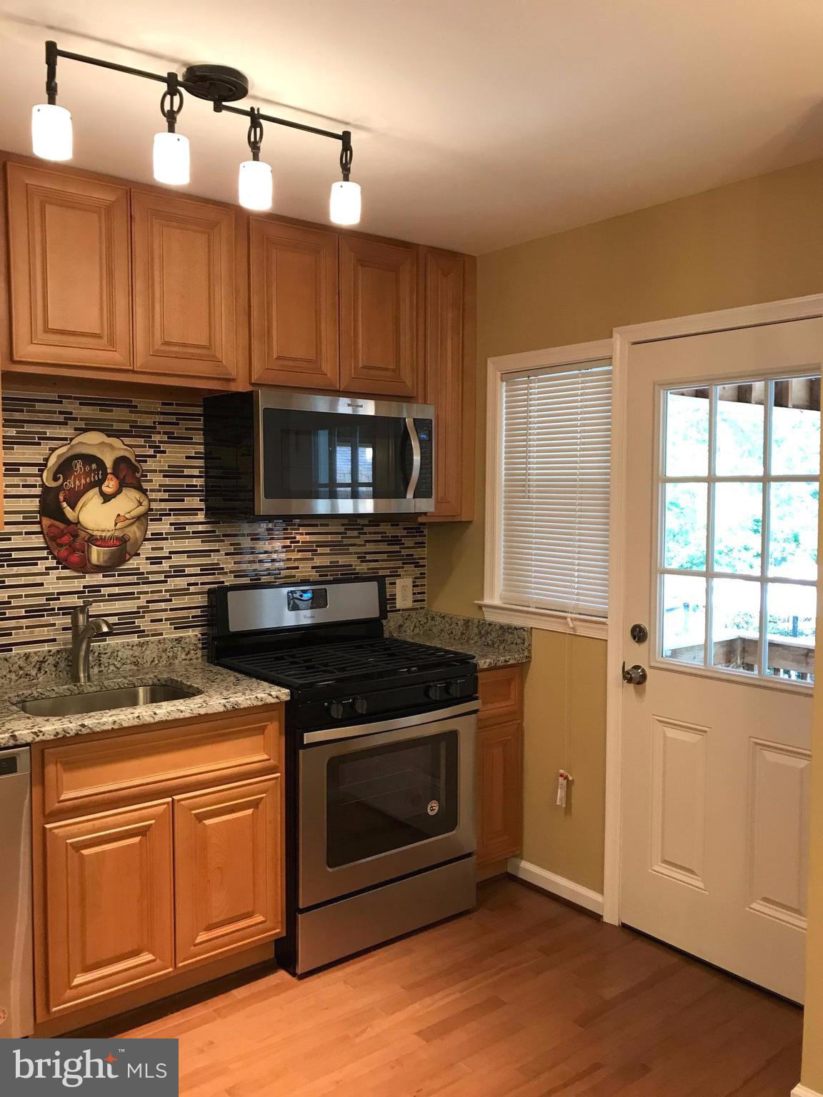 505 Welbrook Road Baltimore, MD 21221 - Photo 3 of 27 a kitchen with stainless steel appliances granite countertop a stove a sink and a microwave