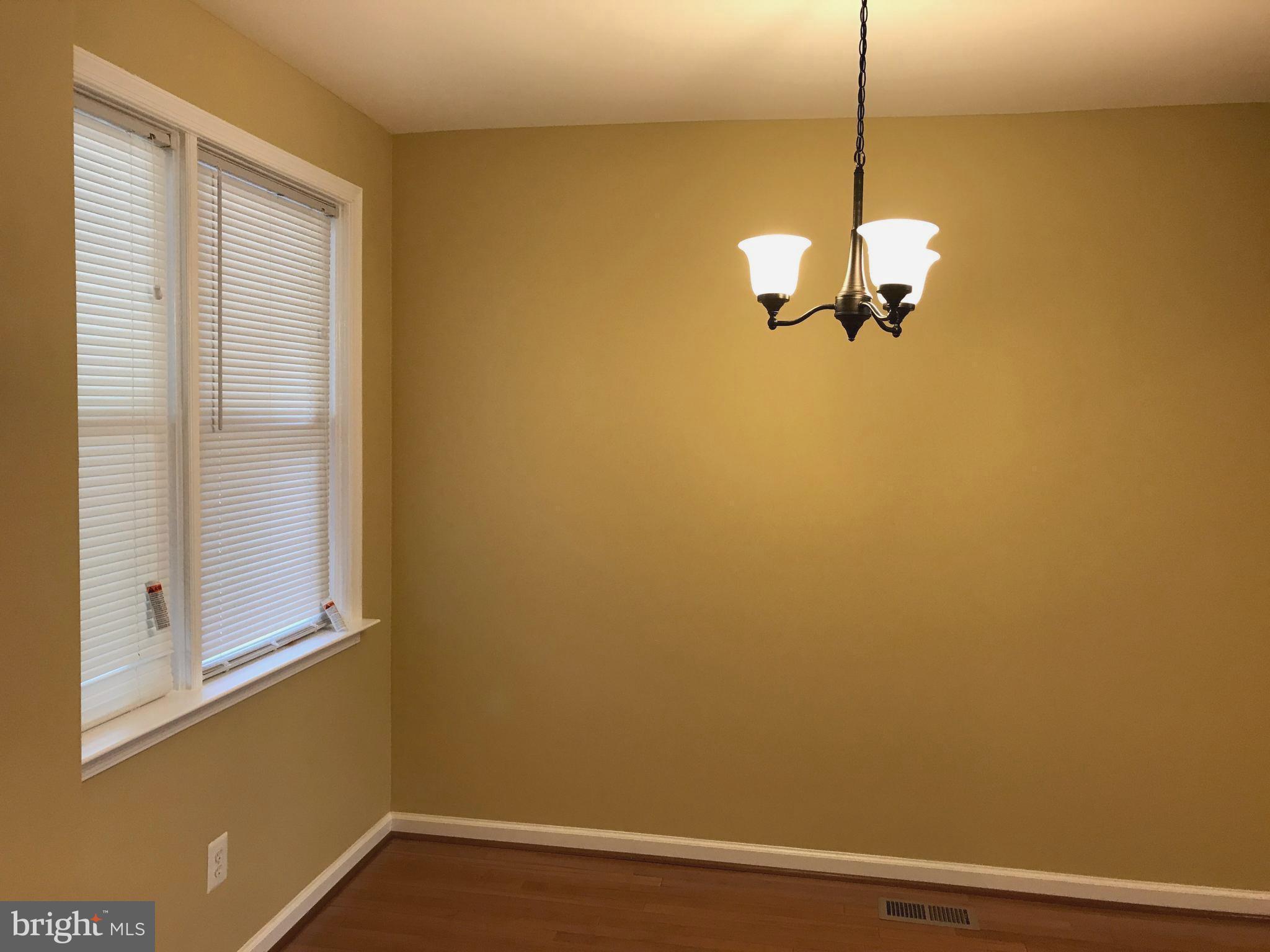 505 Welbrook Road Baltimore, MD 21221 - Photo 6 of 27 a view of a room with a hanging light and hardwood floor