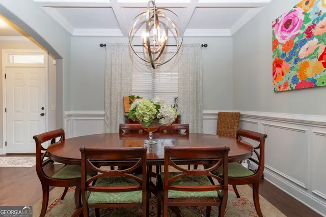 a view of a patio with couches table and chairs and wooden fence