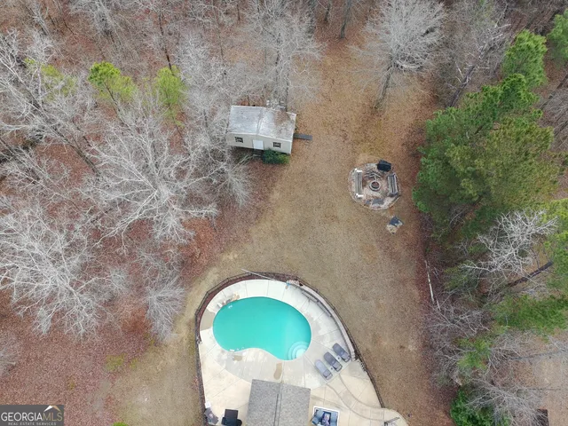 a spacious bedroom with a bed and a chandelier