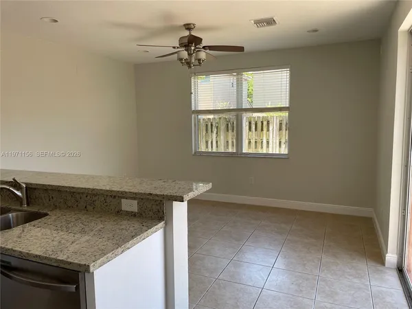 a kitchen with a stove a sink and a window