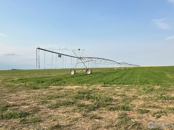 an aerial view of a residential house with a yard and lake view