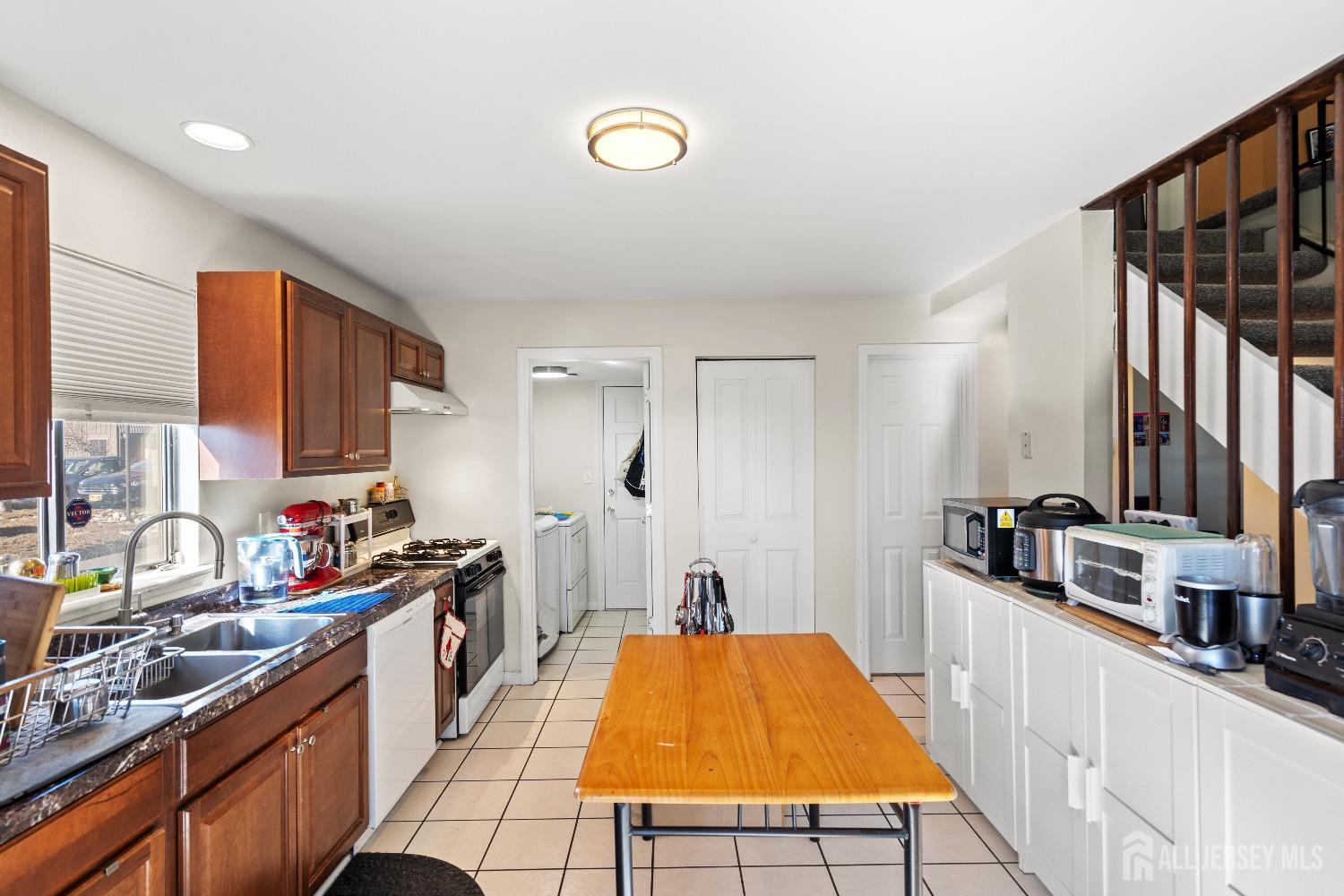 418 Westgate Drive Edison, NJ 08820 - Photo 6 of 26 a kitchen with stainless steel appliances a sink stove and cabinets