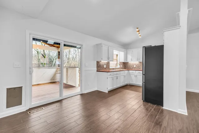 a view of a kitchen with wooden floor and a kitchen